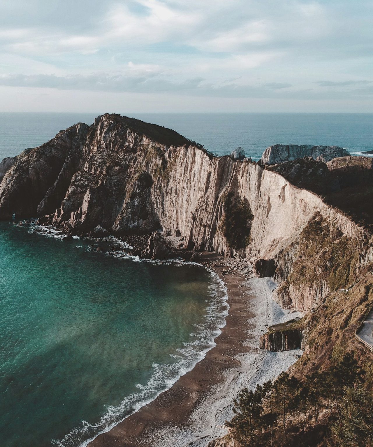 Green cliffs meeting the Cantabrian sea